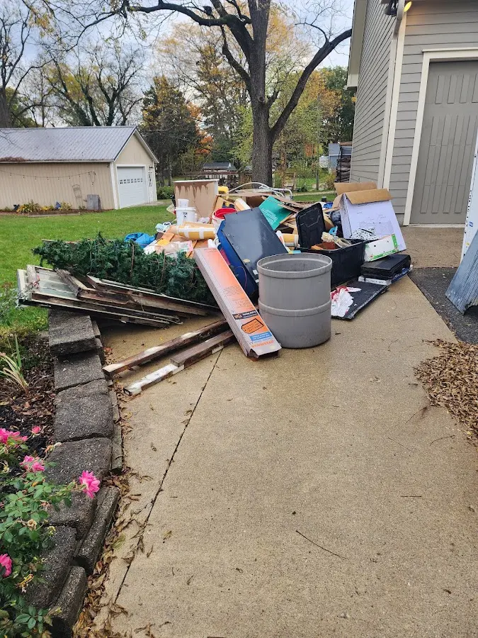 Dumpster being loaded with debris for 3 Yard Dumpster Rental in Inkster